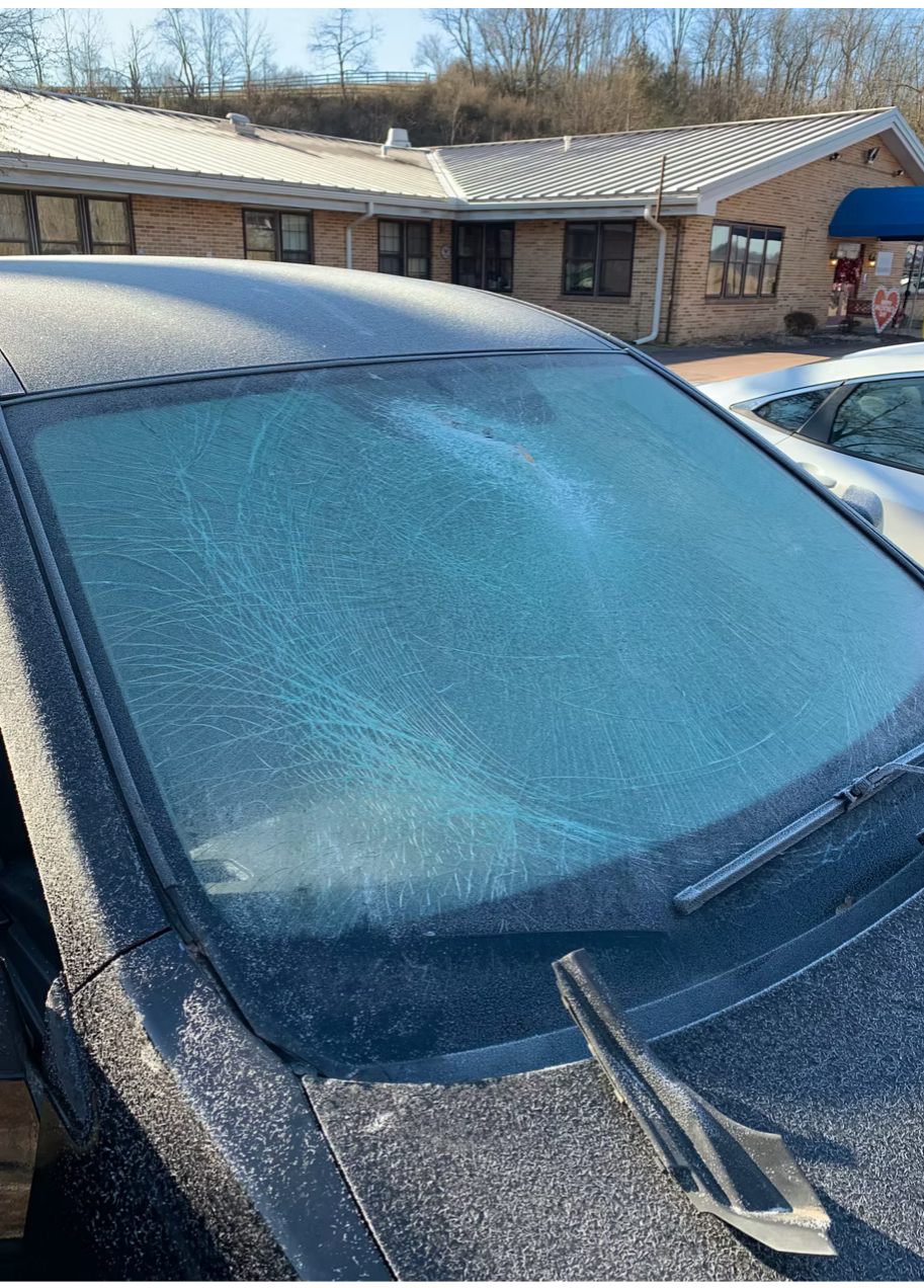 Shattered windshield — dark sedan