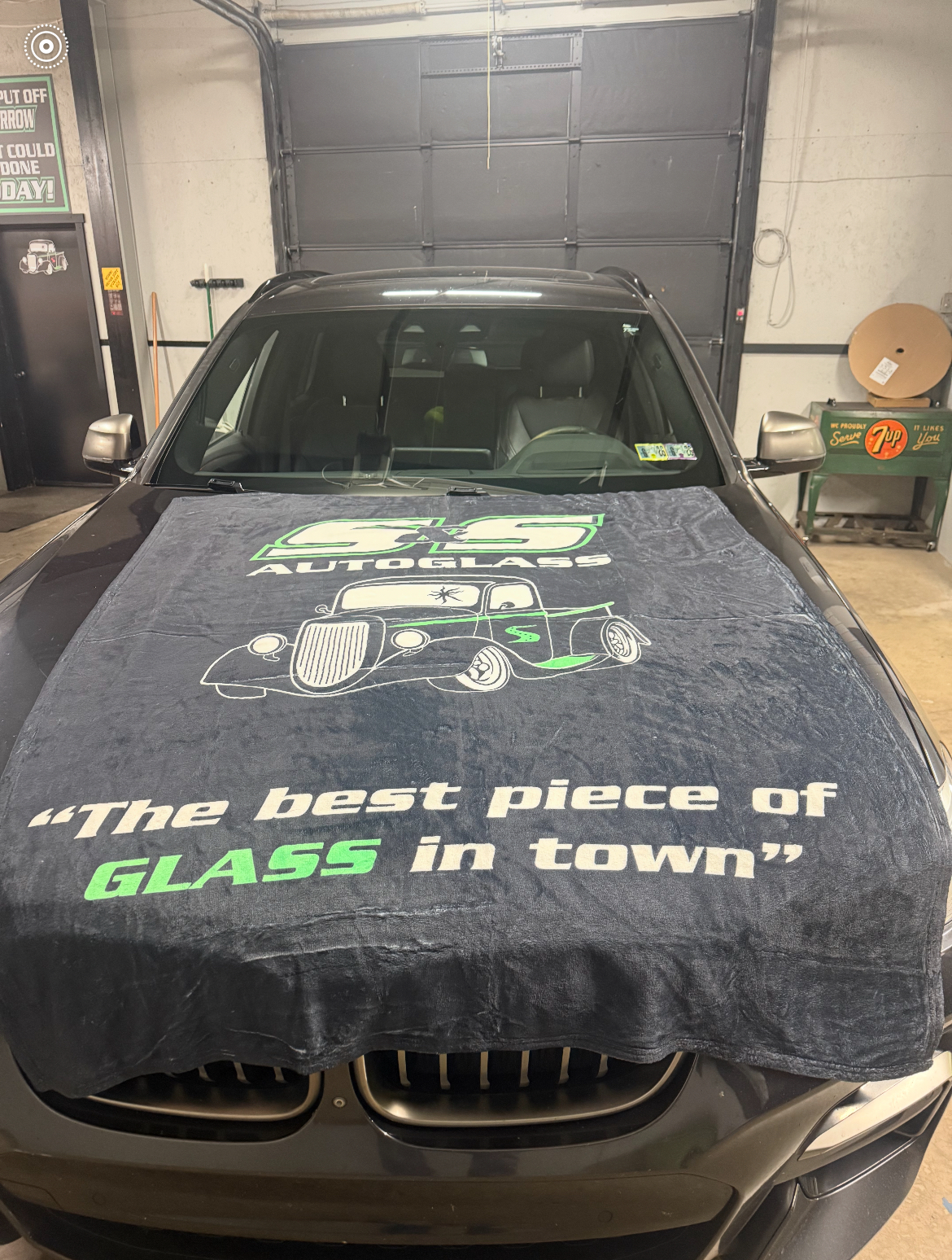 Dark BMW — S&S AutoGlass branded hood cover, windshield replacement
